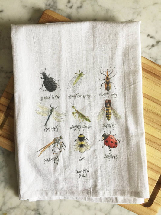 A white tea towel displays 9 beneficial garden bugs: ground beetle, green lacewing, assassin bug, dragonfly, praying mantis, hoverfly, robber fly, bee, and ladybug.