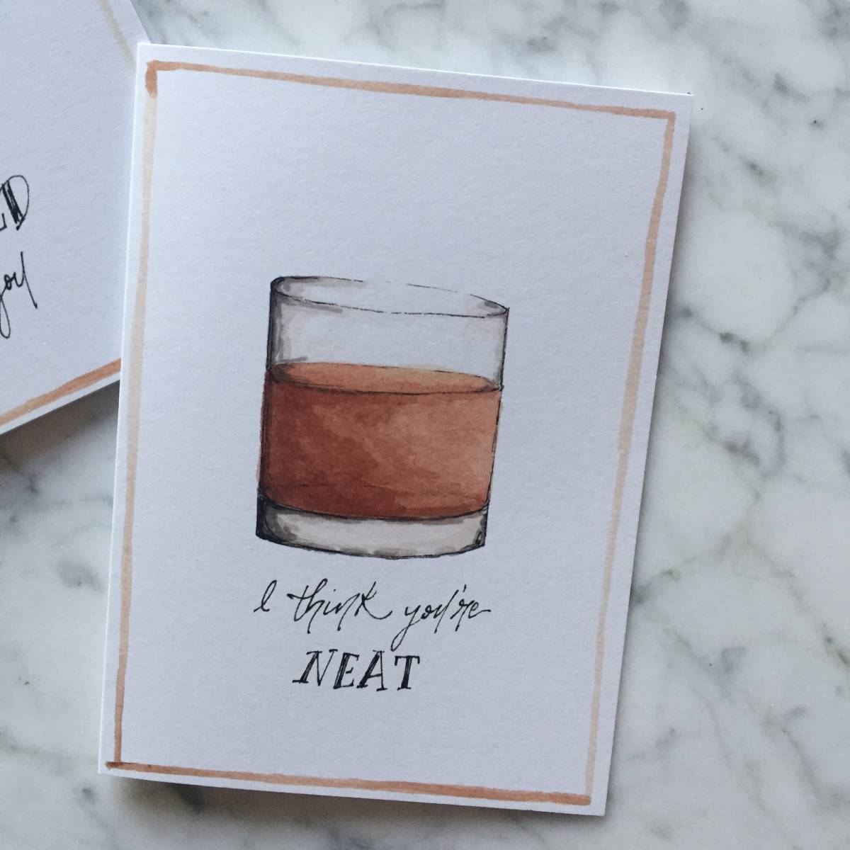 A white notecard with a glass of neat bourbon whiskey and the text "I think you're neat"
