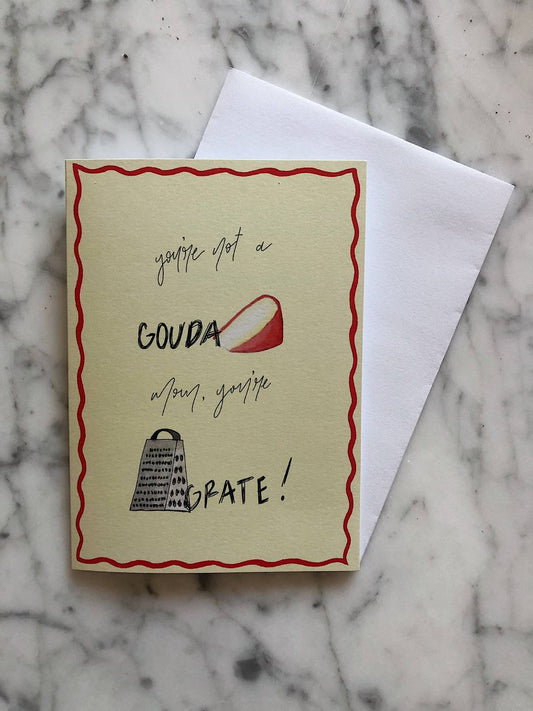 A yellow Mother's Day card with a watercolor illustration of a grater and slice of gouda cheese with the text "you're not a gouda mom, you're grate"