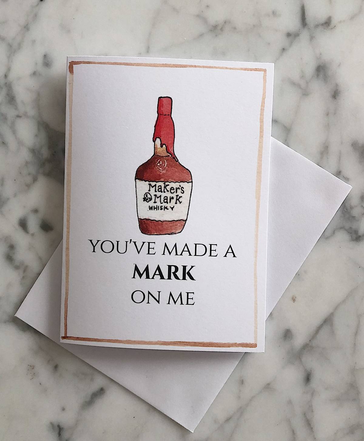 A white bourbon Valentine's Day card with an illustration of a Maker's Mark bottle and the text "you've made a mark on me"